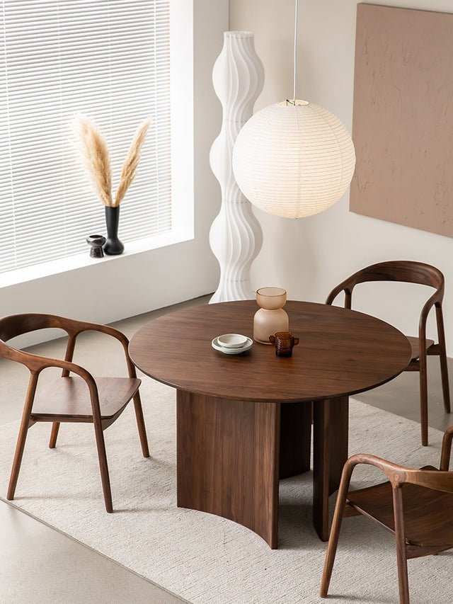 "Elegant round dining table with wooden finish for a cozy dining space."
