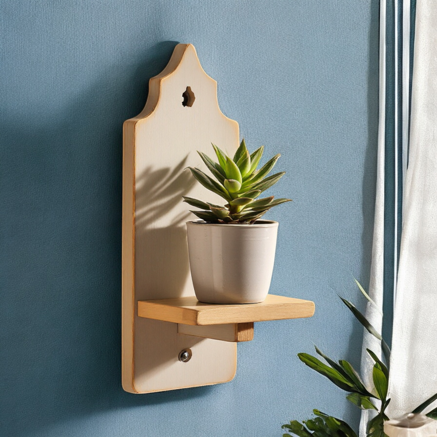 Elegant wooden wall shelf with a unique silhouette, mounted on a blue wall with a small potted plant.