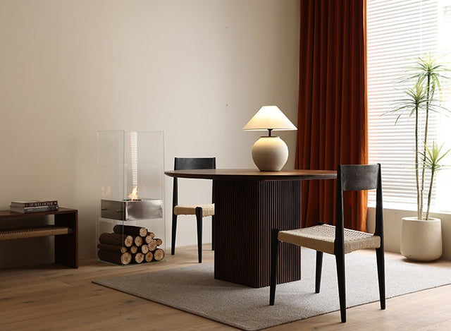 Small dining table paired with wooden chairs, perfect for compact spaces
