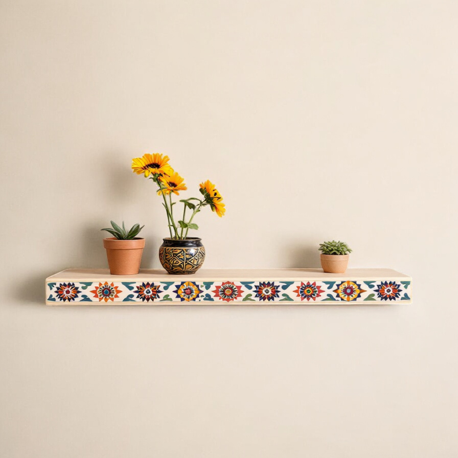 "Hand-painted wooden wall shelf with a multicolored floral border, mounted on a textured wall displaying plants and decorative items."
