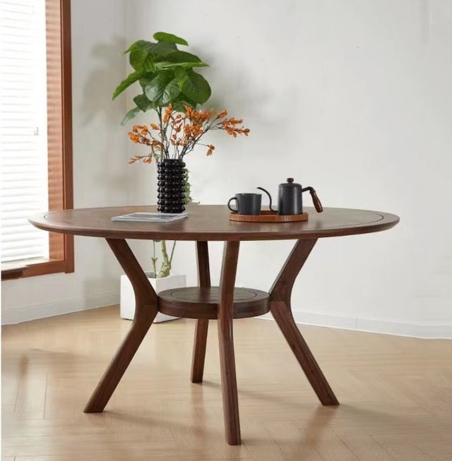 "Elegant round dining table with wooden finish for a cozy dining space."
