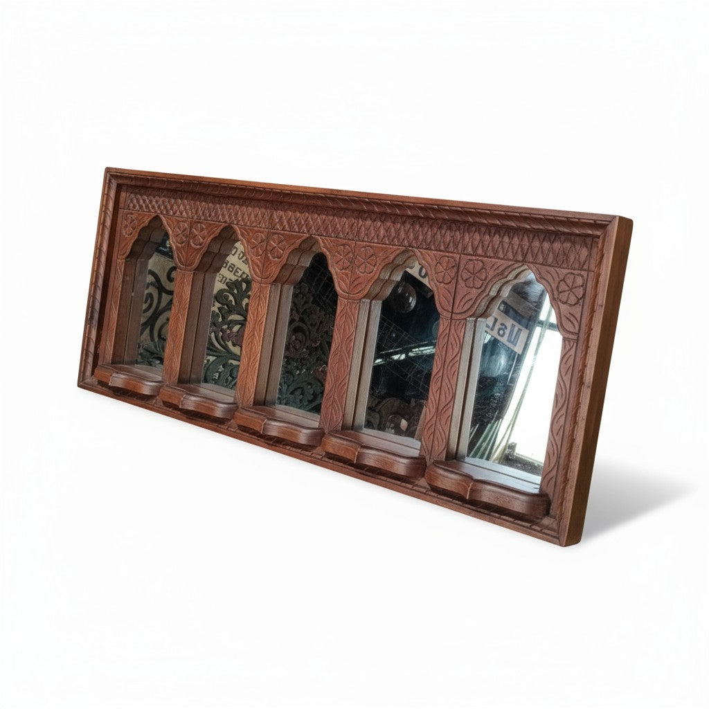 Wooden wall mirror with decorative frame on a white background