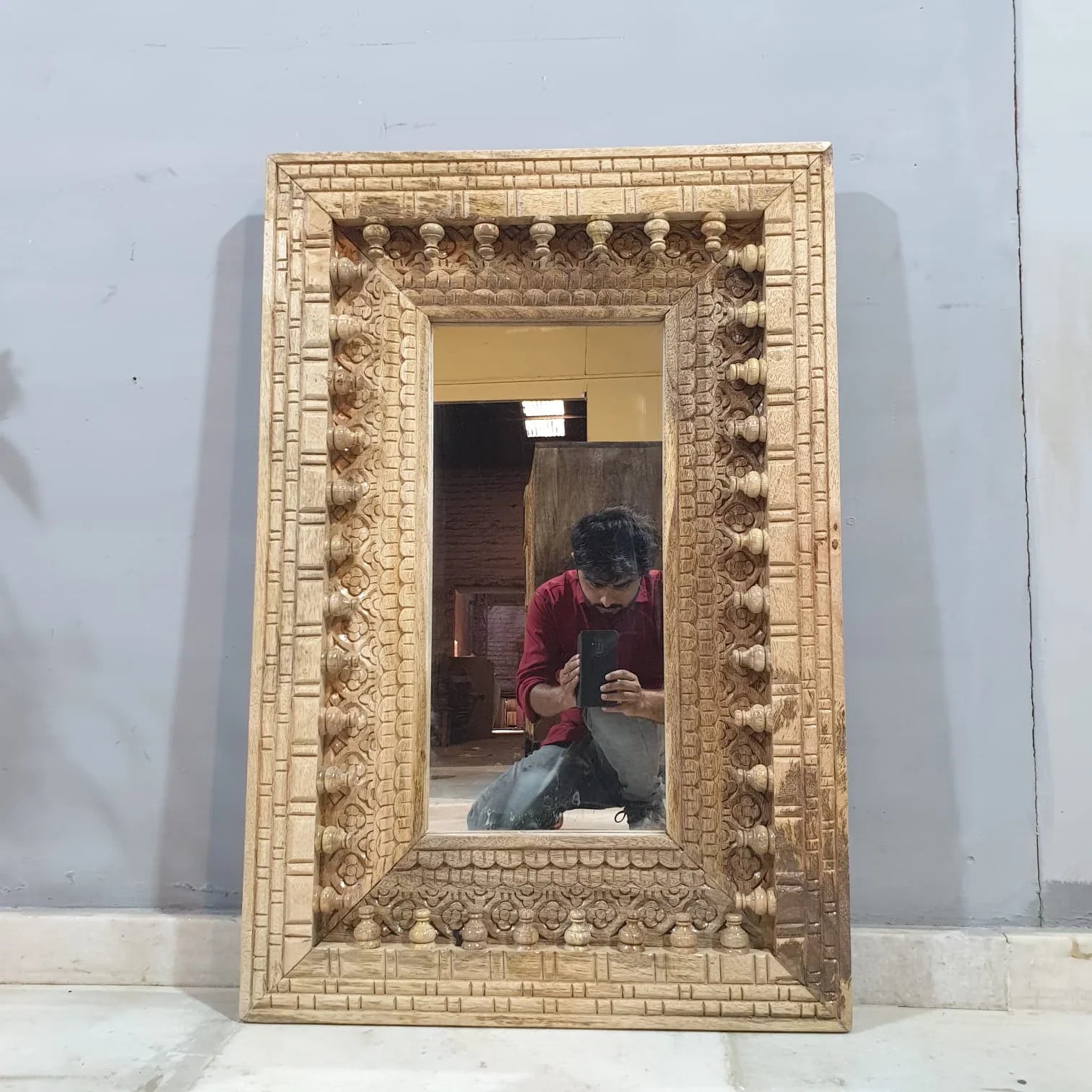 mango wood mirror, carved mirror, natural wood mirror, wall mirror, statement mirror, rustic mirror, architectural mirror, traditional mirror, handmade mirror, artisan mirror, premium mirror, quality mirror, durable mirror, elegant mirror, unique mirror, decorative mirror, focal piece mirror, handcrafted in india, sustainable mango wood, natural wood finish, honey wood, clear coating, hand carved frame, ball and spindle carving, scrolling foliage, basketweave pattern, brick pattern border, dimensional carvi