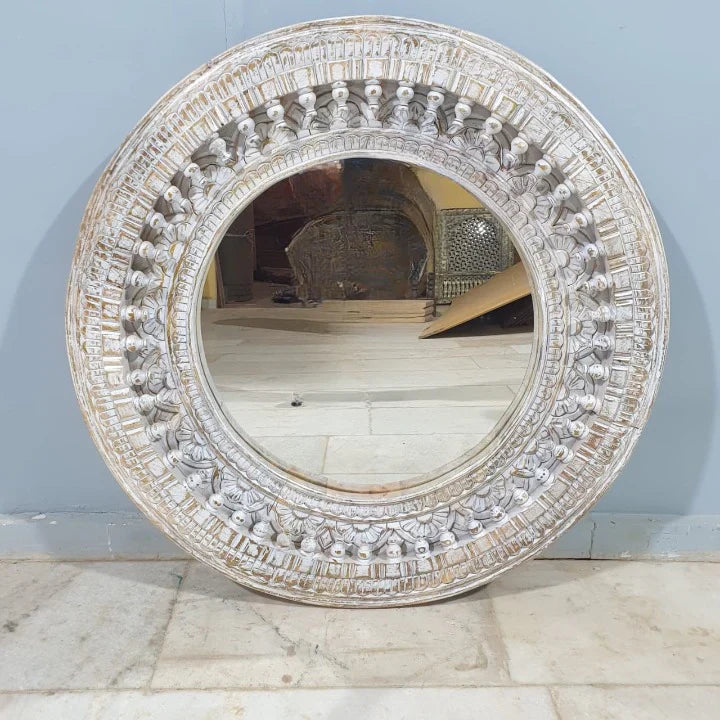 mango wood mirror, carved mirror, round mirror, whitewash mirror, oriental mirror, wall mirror, statement mirror, circular mirror, coastal mirror, bohemian mirror, handmade mirror, artisan mirror, premium mirror, quality mirror, durable mirror, elegant mirror, unique mirror, decorative mirror, focal piece mirror, handcrafted in india, sustainable mango wood, whitewash finish, white wash, warm wood undertones, hand carved frame, ball and spindle carving, ornamental garlands, concentric circles, basketweave p