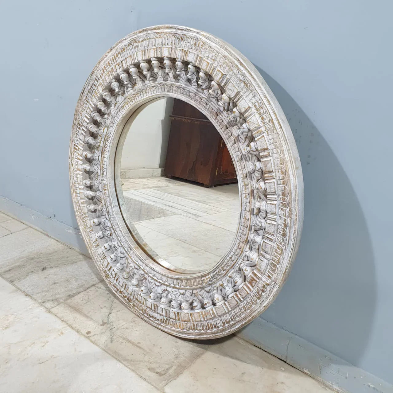 mango wood mirror, carved mirror, round mirror, whitewash mirror, oriental mirror, wall mirror, statement mirror, circular mirror, coastal mirror, bohemian mirror, handmade mirror, artisan mirror, premium mirror, quality mirror, durable mirror, elegant mirror, unique mirror, decorative mirror, focal piece mirror, handcrafted in india, sustainable mango wood, whitewash finish, white wash, warm wood undertones, hand carved frame, ball and spindle carving, ornamental garlands, concentric circles, basketweave p