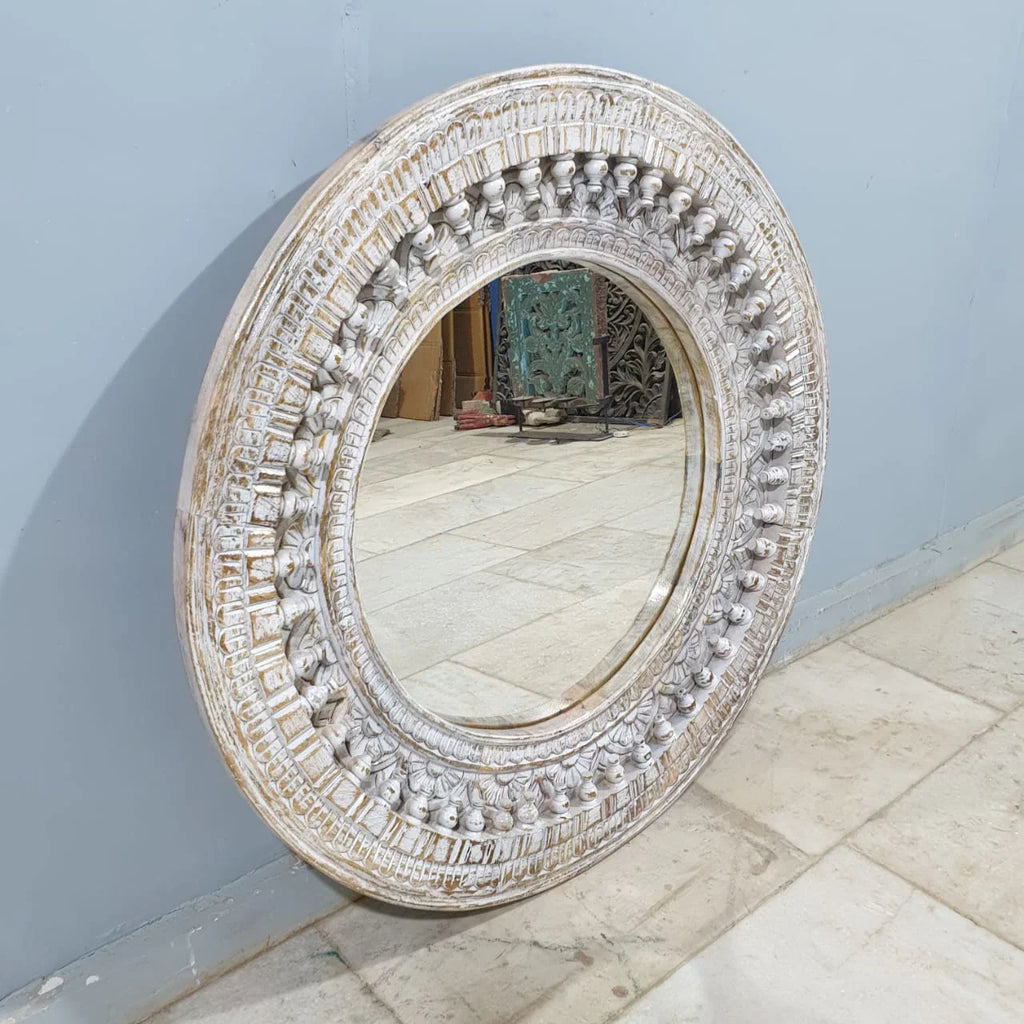 mango wood mirror, carved mirror, round mirror, whitewash mirror, oriental mirror, wall mirror, statement mirror, circular mirror, coastal mirror, bohemian mirror, handmade mirror, artisan mirror, premium mirror, quality mirror, durable mirror, elegant mirror, unique mirror, decorative mirror, focal piece mirror, handcrafted in india, sustainable mango wood, whitewash finish, white wash, warm wood undertones, hand carved frame, ball and spindle carving, ornamental garlands, concentric circles, basketweave p
