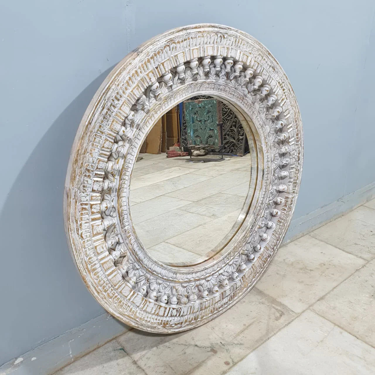 mango wood mirror, carved mirror, round mirror, whitewash mirror, oriental mirror, wall mirror, statement mirror, circular mirror, coastal mirror, bohemian mirror, handmade mirror, artisan mirror, premium mirror, quality mirror, durable mirror, elegant mirror, unique mirror, decorative mirror, focal piece mirror, handcrafted in india, sustainable mango wood, whitewash finish, white wash, warm wood undertones, hand carved frame, ball and spindle carving, ornamental garlands, concentric circles, basketweave p
