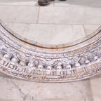 mango wood mirror, carved mirror, round mirror, whitewash mirror, oriental mirror, wall mirror, statement mirror, circular mirror, coastal mirror, bohemian mirror, handmade mirror, artisan mirror, premium mirror, quality mirror, durable mirror, elegant mirror, unique mirror, decorative mirror, focal piece mirror, handcrafted in india, sustainable mango wood, whitewash finish, white wash, warm wood undertones, hand carved frame, ball and spindle carving, ornamental garlands, concentric circles, basketweave p