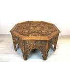 hand carved coffee table, solid wood coffee table, octagonal coffee table, carved wood table, natural wood table, indian furniture, living room table, statement coffee table, mehrab arch table, handmade coffee table, artisan made table, premium wood table, quality furniture, durable table, sturdy table, timeless table, elegant table, ornate table, unique table, sculptural table, focal piece table, handcrafted in india, sustainable wood furniture, star medallion design, geometric patterns, scrolling vines, f