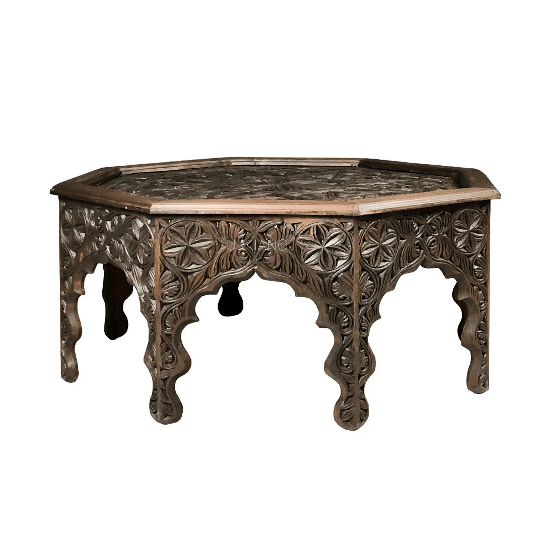 hand carved coffee table, solid wood coffee table, octagonal coffee table, carved wood table, indian furniture, living room table, statement coffee table, mehrab arch table, handmade coffee table, artisan made table, premium wood table, quality furniture, durable table, sturdy table, timeless table, elegant table, ornate table, unique table, sculptural table, focal piece table, handcrafted in india, sustainable wood furniture, star medallion design, geometric patterns, scrolling vines, floral rosettes, mehr