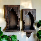 Set of two Jodhpur hand-carved Jharokha wall decor niches with dark wood antique wood art finish, mounted on a wall. Handcrafted in Jodhpur, Rajasthan. Ideal for antique home decor and decorative display.