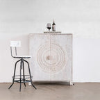 hand carved bar cabinet, mango wood bar cabinet, whitewashed bar cabinet, bar cabinet on stand, metal stand cabinet, sunburst carved cabinet, wine cabinet, liquor cabinet, home bar cabinet, dining room bar cabinet, living room bar cabinet, storage cabinet, 2 door cabinet, 2 drawer cabinet, wine rack cabinet, handmade bar cabinet, artisan made cabinet, premium wood cabinet, quality wood furniture, durable bar cabinet, sturdy cabinet, timeless bar cabinet, elegant cabinet, statement bar cabinet, industrial st