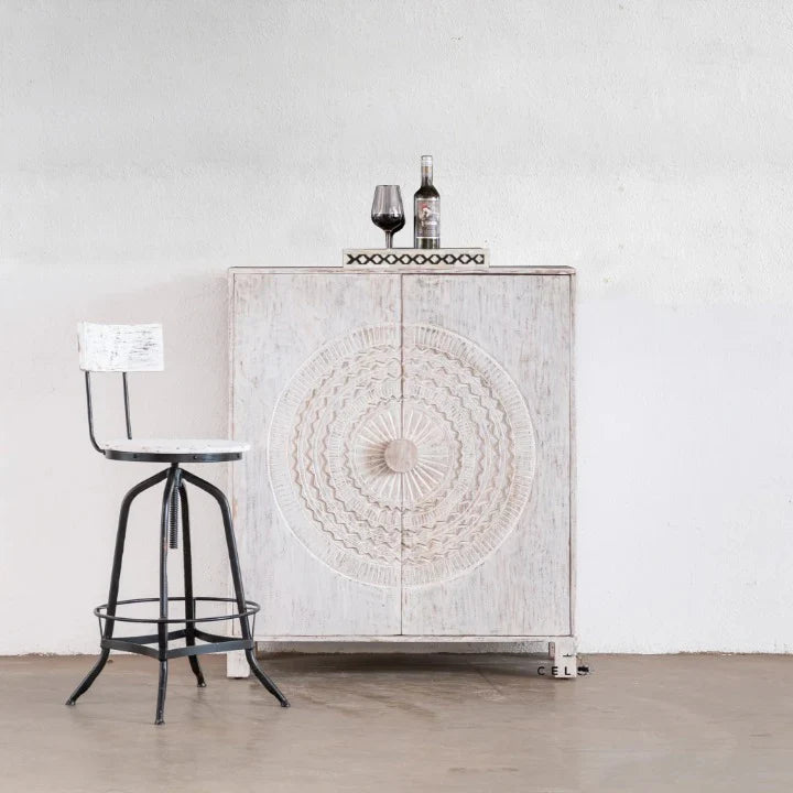 hand carved bar cabinet, mango wood bar cabinet, whitewashed bar cabinet, bar cabinet on stand, metal stand cabinet, sunburst carved cabinet, wine cabinet, liquor cabinet, home bar cabinet, dining room bar cabinet, living room bar cabinet, storage cabinet, 2 door cabinet, 2 drawer cabinet, wine rack cabinet, handmade bar cabinet, artisan made cabinet, premium wood cabinet, quality wood furniture, durable bar cabinet, sturdy cabinet, timeless bar cabinet, elegant cabinet, statement bar cabinet, industrial st