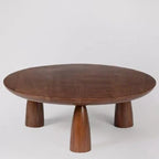 acacia wood coffee table, round coffee table, dark brown table, low coffee table, minimalist table, conical leg table, tapered leg table, scandinavian table, japanese table, modern table, indian furniture, living room table, statement coffee table, handmade coffee table, artisan made table, premium wood table, quality furniture, durable table, sturdy table, timeless table, elegant table, unique table, sculptural table, focal piece table, handcrafted in india, sustainable acacia wood, dark wood finish, natur
