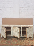 Statement buffet with openwork lattice panels and distressed whitewash patina.

