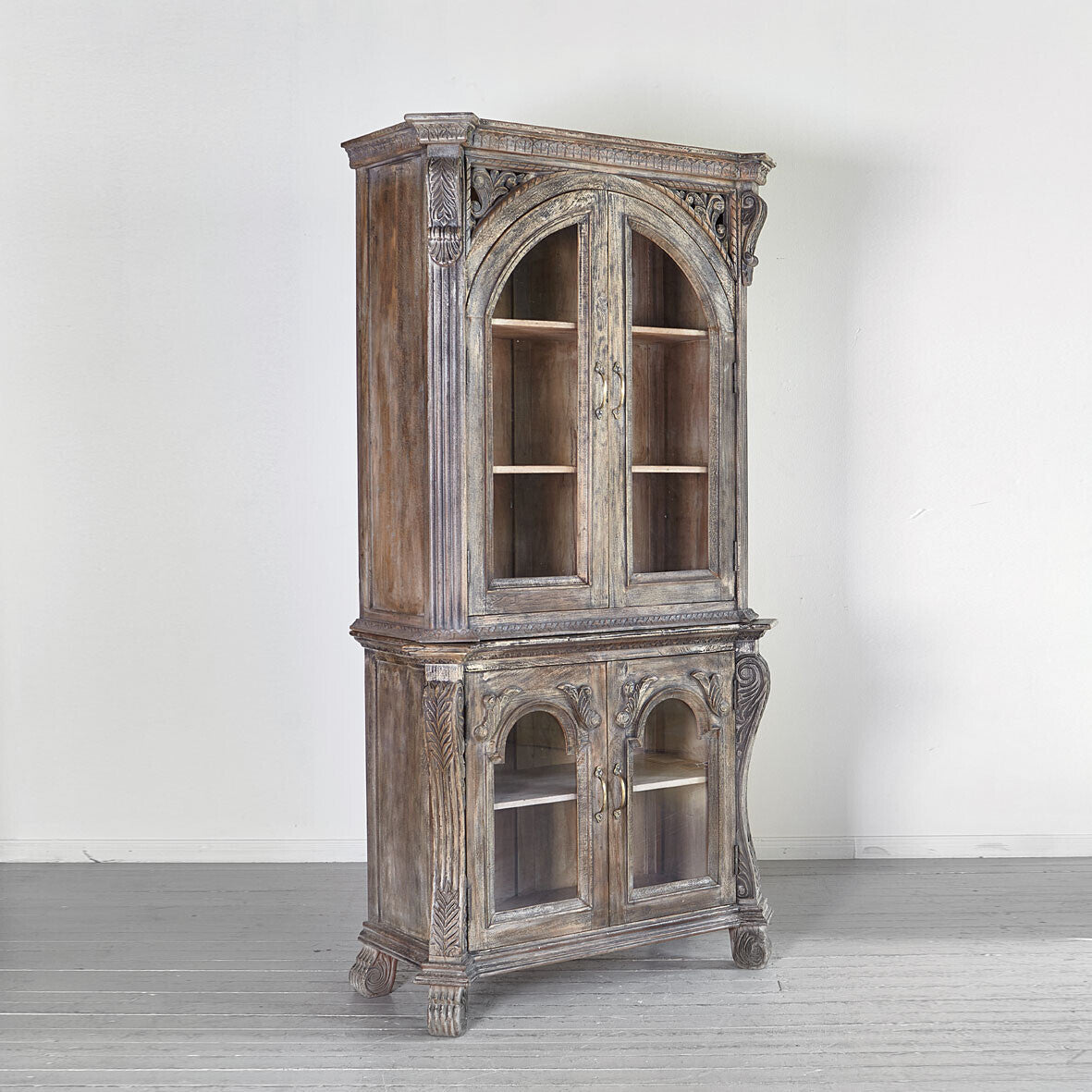 Vintage wooden cabinet with intricate carvings on a white background