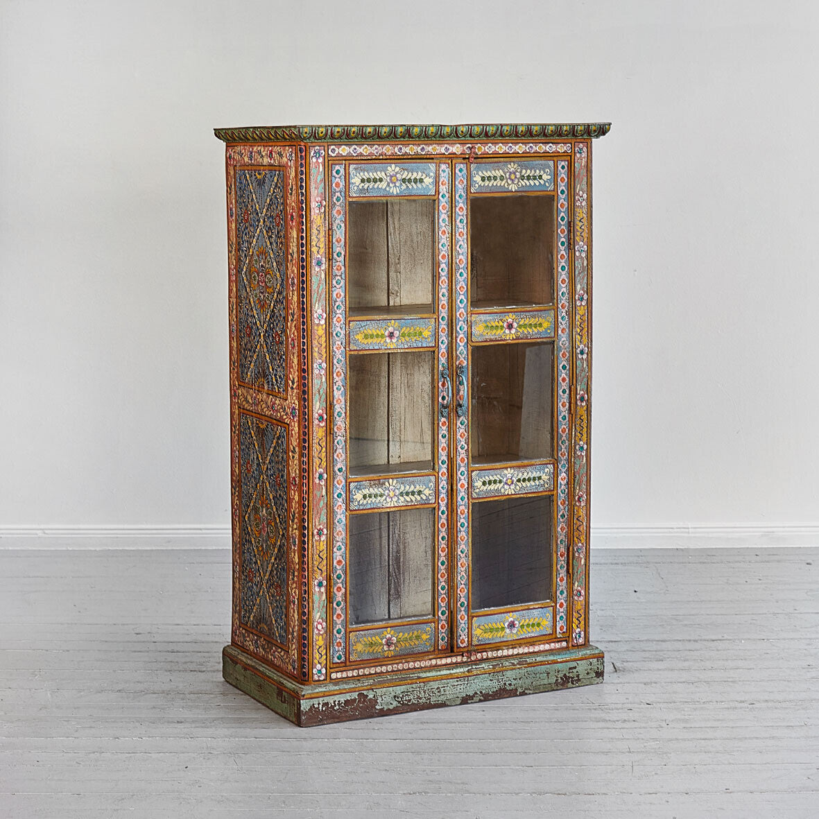 Decorative cabinet with intricate patterns on a white background