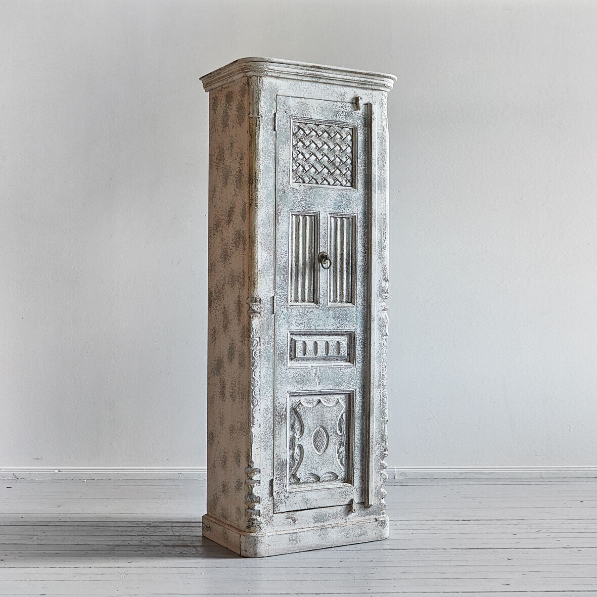 Vintage-style wooden cabinet with intricate carvings on a white background