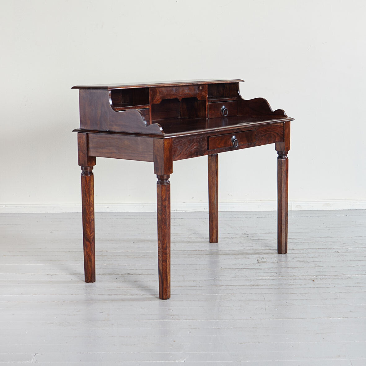 Wooden desk with a shelf and drawers on a white background
