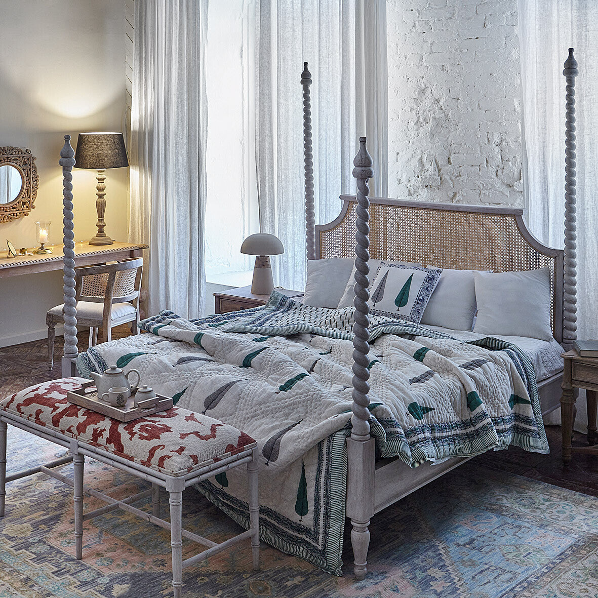 Grand four-poster double bed made of acacia wood and natural cane weaving.