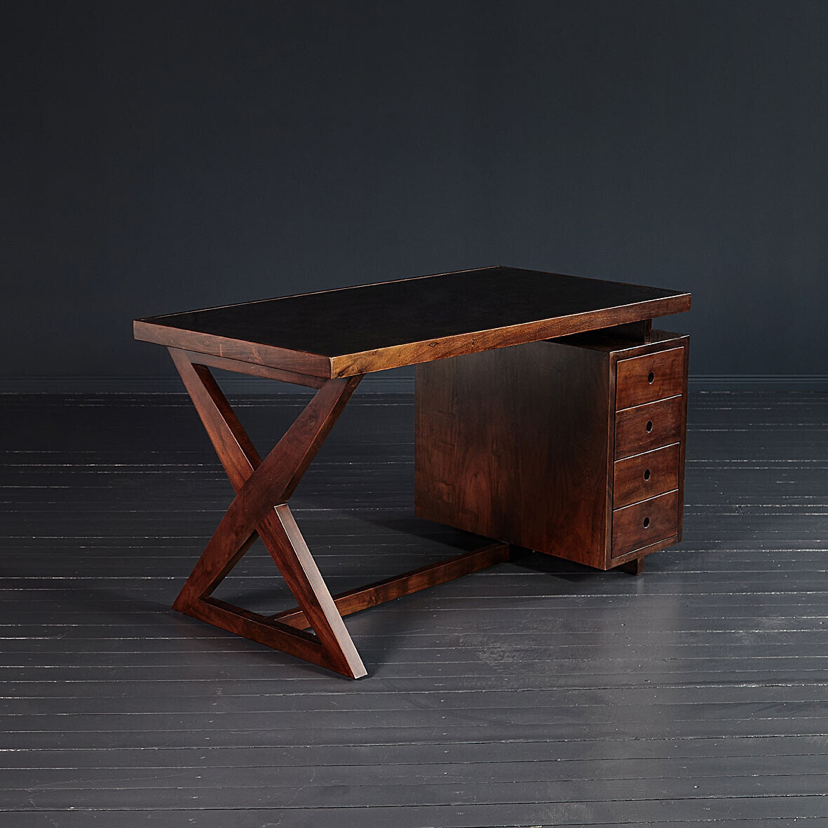 Wooden desk with a dark finish on a black background