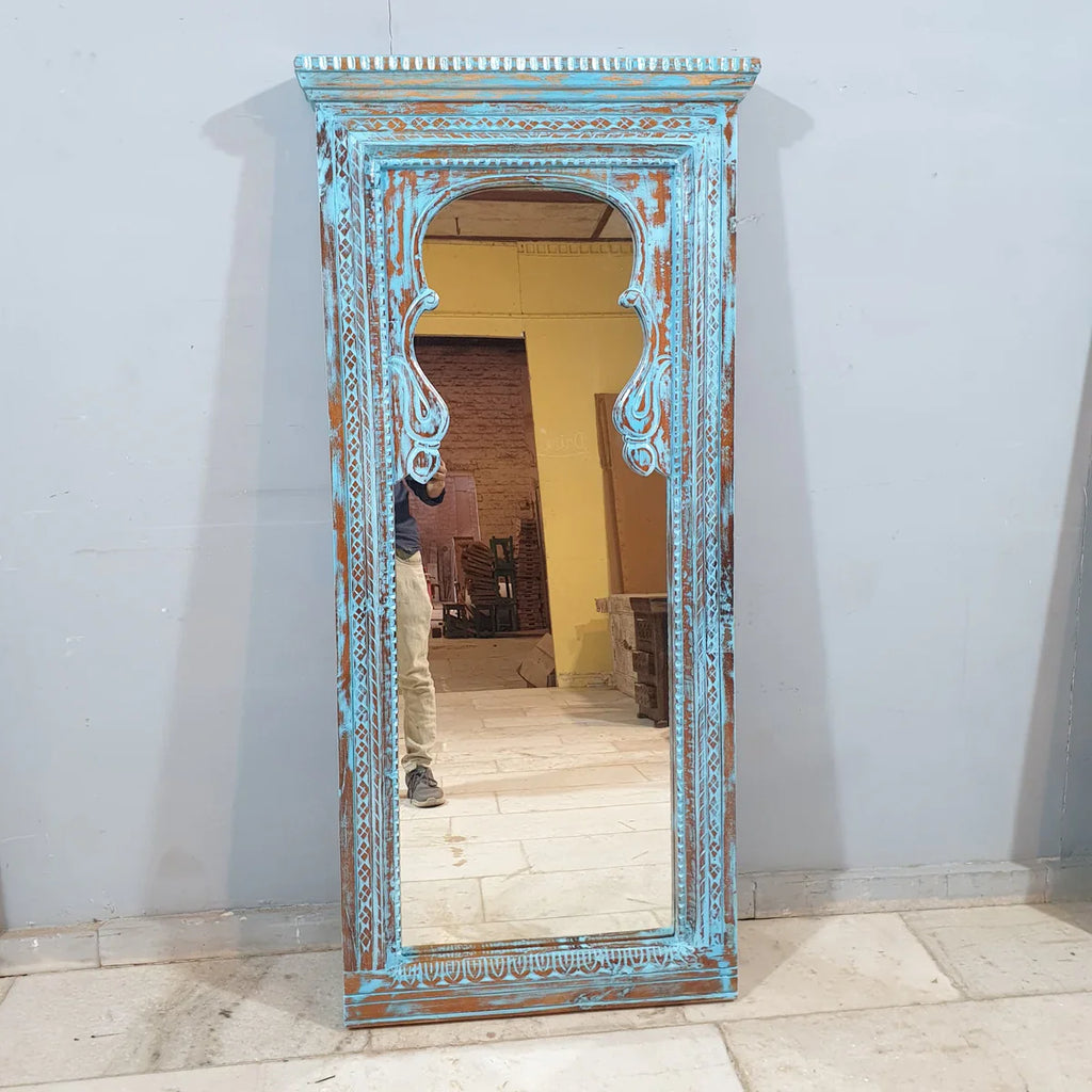hand carved mirror, wooden frame mirror, rustic blue mirror, turquoise mirror, distressed blue mirror, full length mirror, wall mirror, mehrab arch mirror, arched mirror, entryway mirror, narrow mirror, dressing mirror, decorative mirror, indian furniture, handmade mirror, artisan made mirror, premium wood mirror, quality mirror, durable mirror, sturdy mirror, timeless mirror, elegant mirror, statement mirror, ornate mirror, unique mirror, sculptural mirror, focal piece mirror, handcrafted in india, sustain