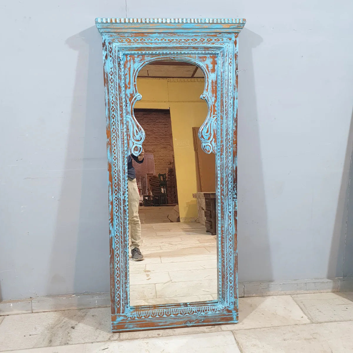 hand carved mirror, wooden frame mirror, rustic blue mirror, turquoise mirror, distressed blue mirror, full length mirror, wall mirror, mehrab arch mirror, arched mirror, entryway mirror, narrow mirror, dressing mirror, decorative mirror, indian furniture, handmade mirror, artisan made mirror, premium wood mirror, quality mirror, durable mirror, sturdy mirror, timeless mirror, elegant mirror, statement mirror, ornate mirror, unique mirror, sculptural mirror, focal piece mirror, handcrafted in india, sustain