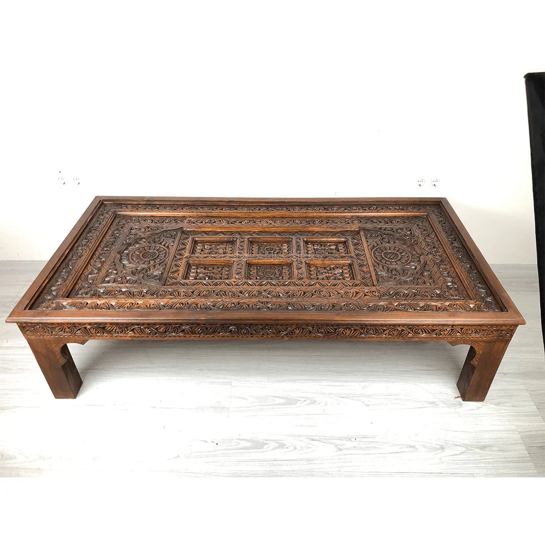 hand carved coffee table, solid wood coffee table, large coffee table, carved wood table, rectangular coffee table, indian furniture, living room table, statement coffee table, handmade coffee table, artisan made table, premium wood table, quality furniture, durable table, sturdy table, timeless table, elegant table, ornate table, unique table, sculptural table, focal piece table, handcrafted in india, sustainable wood furniture, warm wood finish, geometric borders, floral rosettes, scrolling acanthus, six 