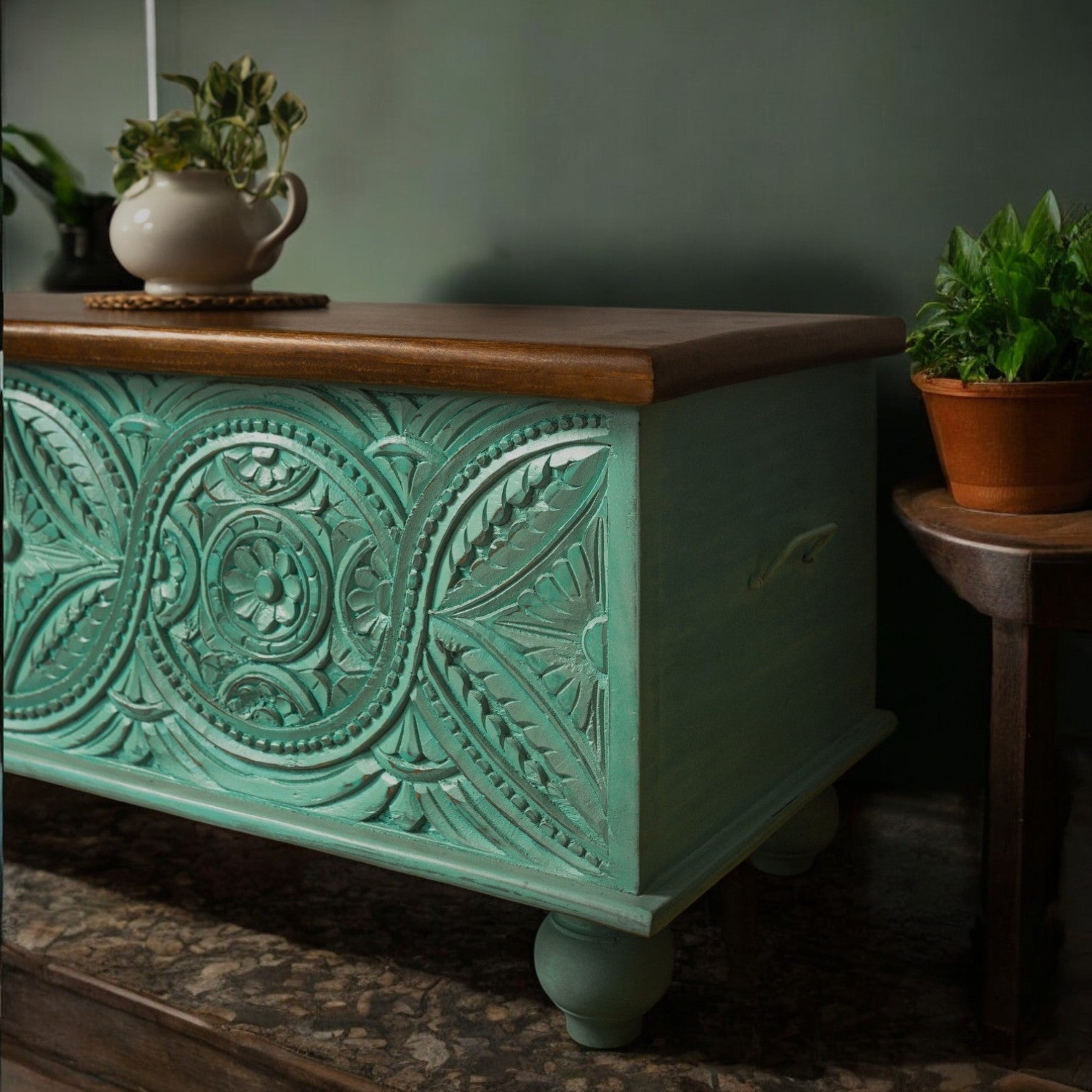 Vibrant teal decorative storage trunk styled as a rustic centerpiece with artisan detailing.
