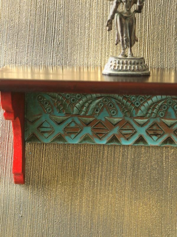 Close-up of intricate flower carvings on vibrant wooden wall shelf