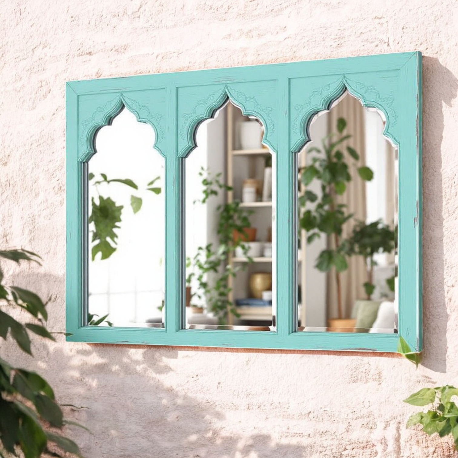 "Mint green Jharokha wall mirror with a triple arch design, reflecting a living room interior."

