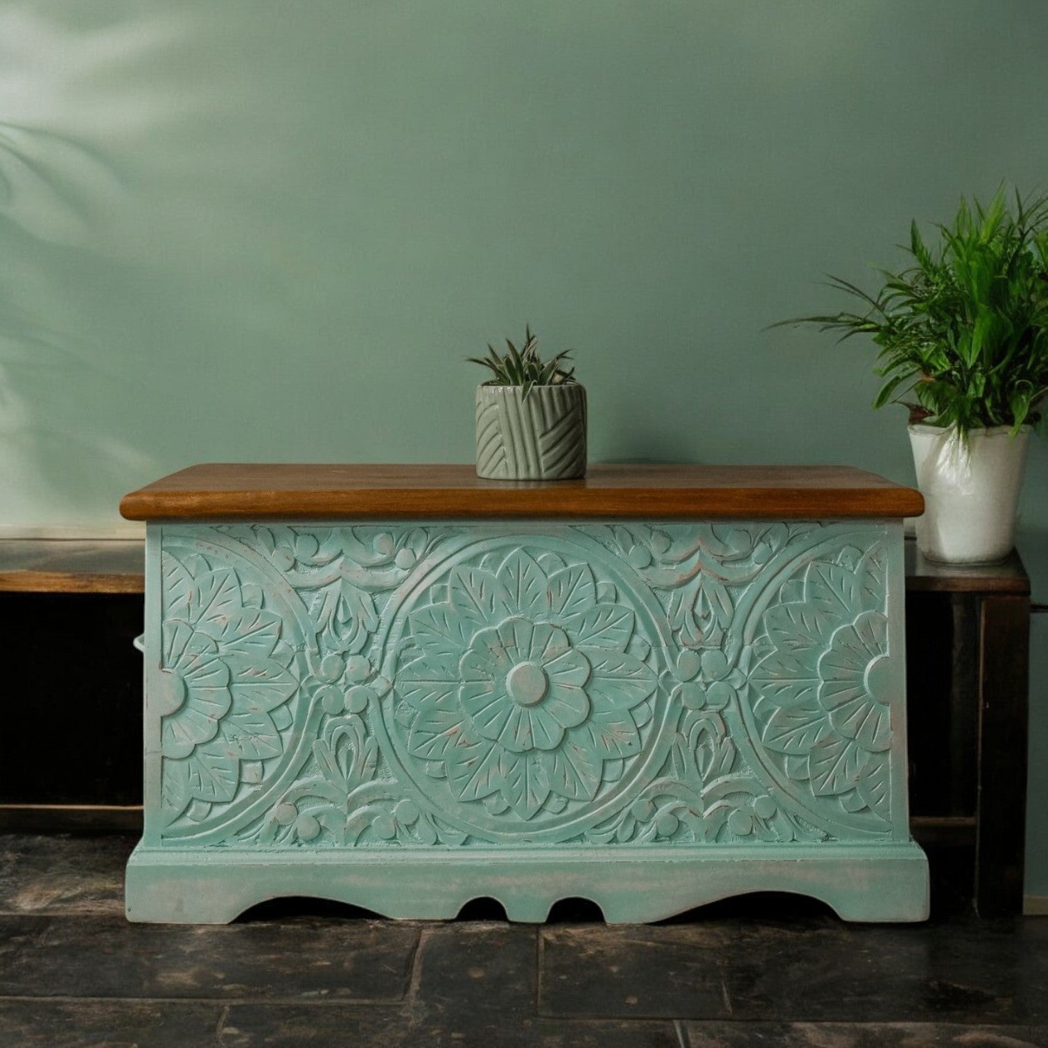 Handcrafted mango wood chest with light blue distressed finish, natural wood lid, and intricate carvings.
