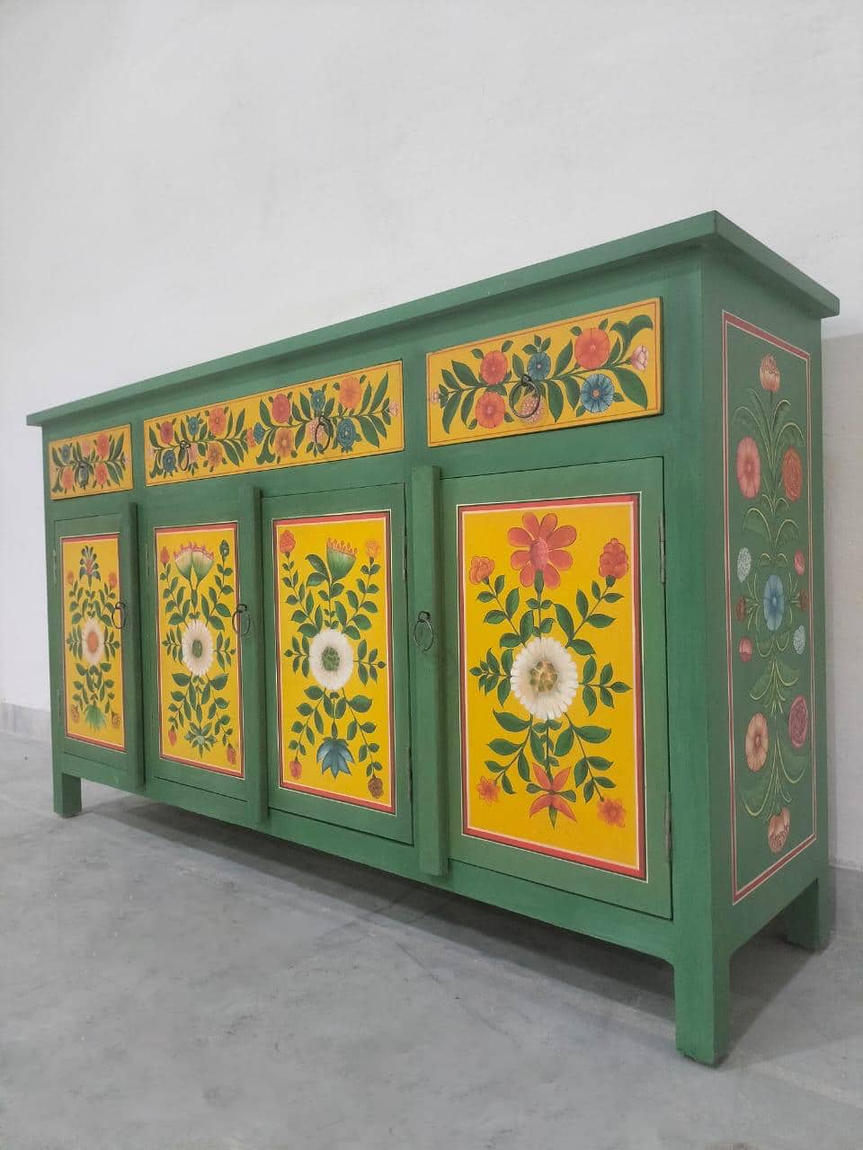 hand painted sideboard, solid wood sideboard, floral sideboard, folk art sideboard, green sideboard, painted cabinet, storage sideboard, bohemian sideboard, colorful sideboard, accent cabinet, living room storage, hallway cabinet, dining room cabinet, bedroom storage, statement sideboard, handmade sideboard, artisan made cabinet, premium wood furniture, quality furniture, durable cabinet, sturdy sideboard, timeless furniture, elegant sideboard, unique cabinet, decorative sideboard, focal piece cabinet, hand