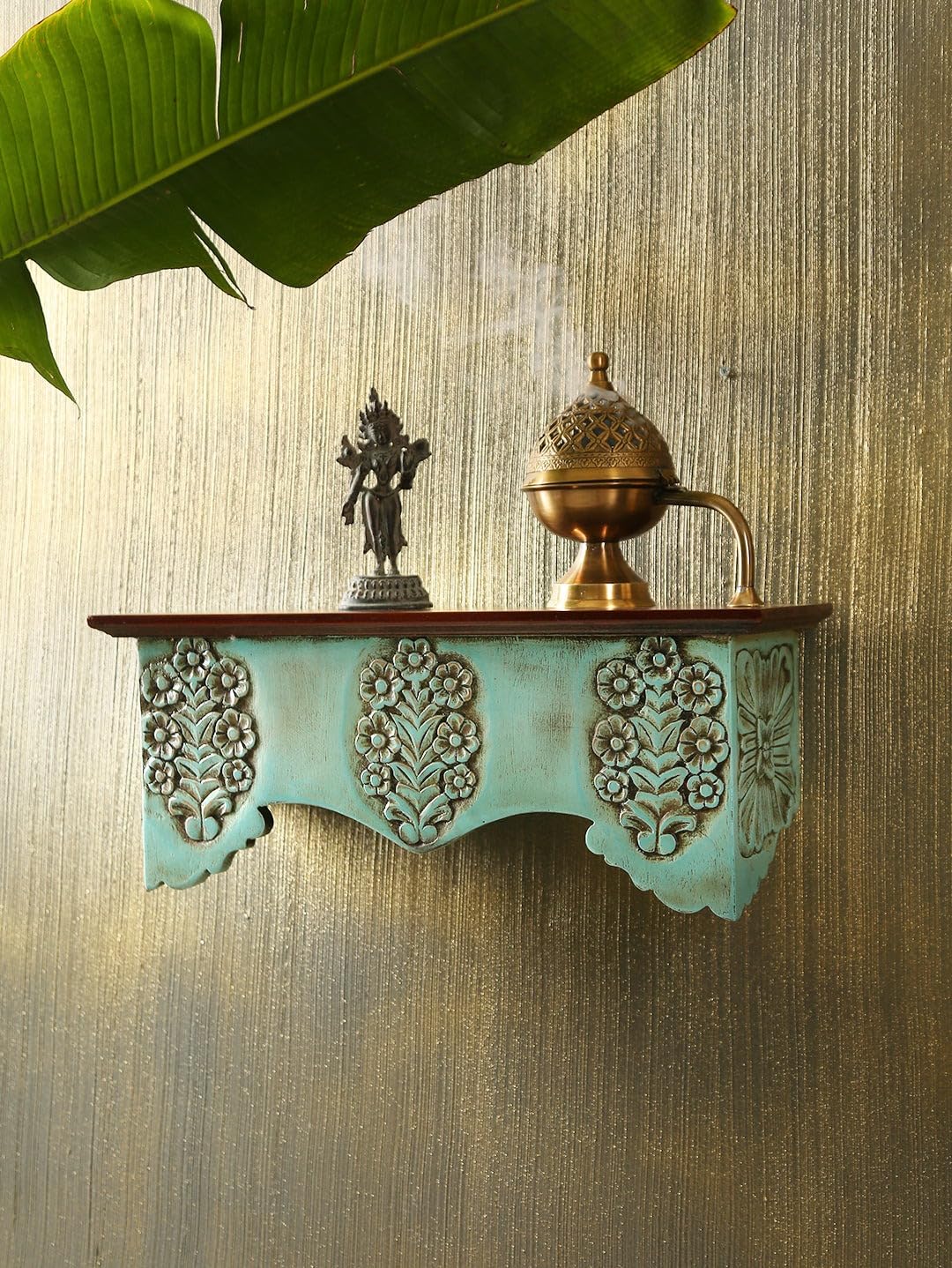 Stylish wall mounted wooden shelves in bedroom with books and plants