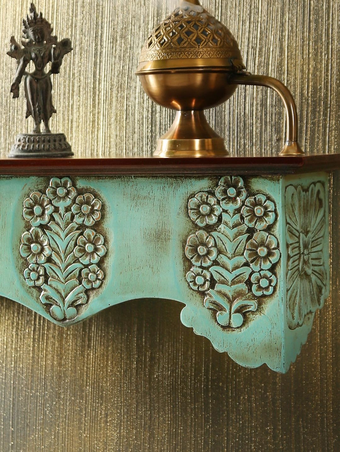 Intricate flower carvings on rustic green wooden wall shelf – modern shelf decor