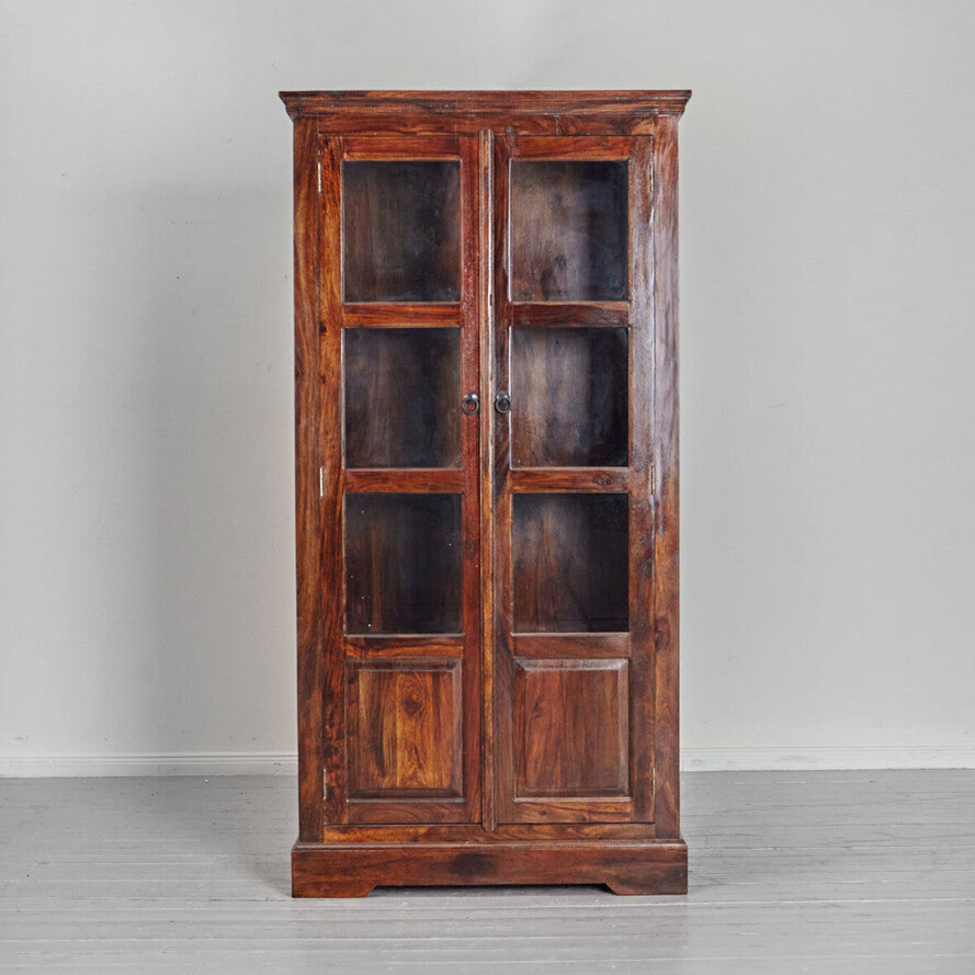 Wooden cabinet with glass doors on a gray background