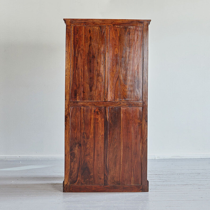 Wooden wardrobe against a white wall