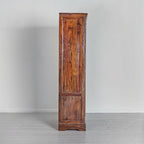 Wooden cabinet with a rustic finish on a plain background