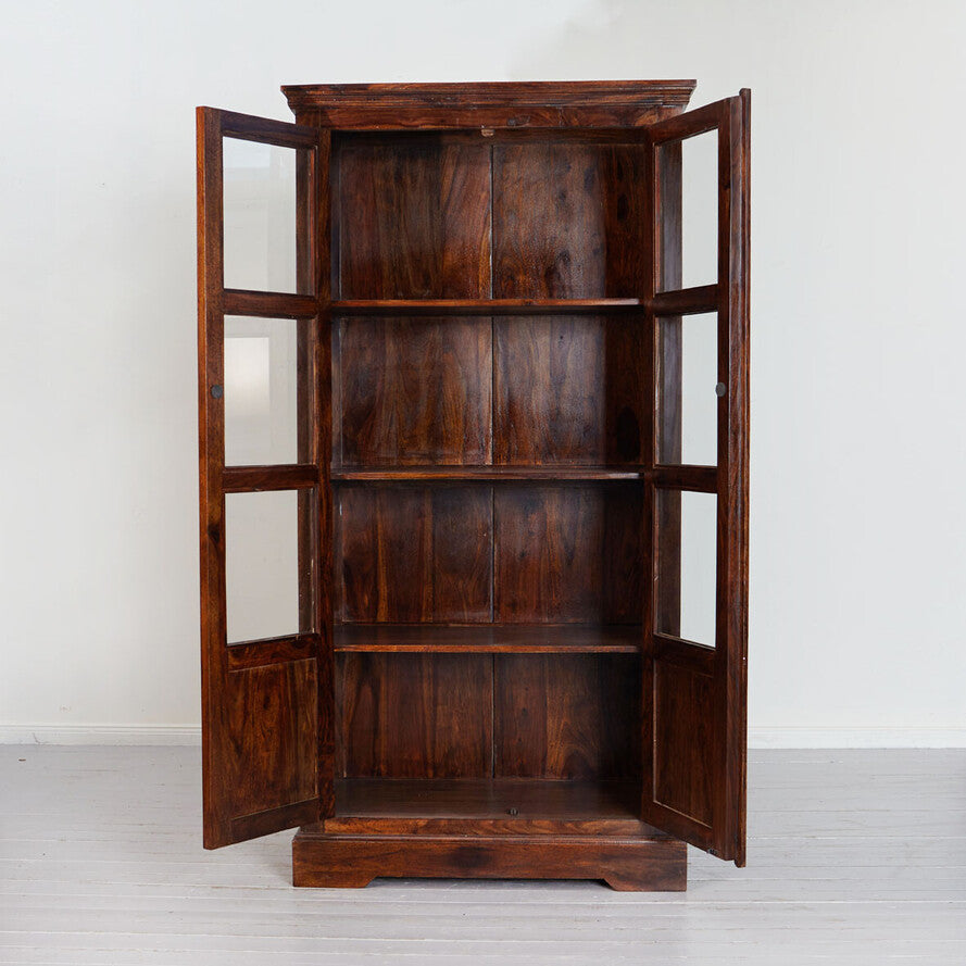 Wooden bookshelf with glass doors on a white background
