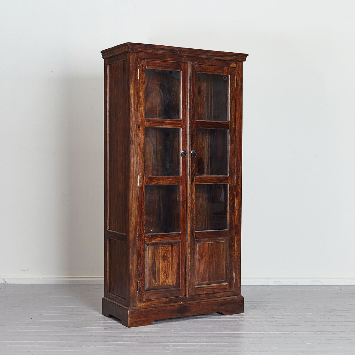 Wooden cabinet with glass doors on a white background
