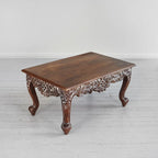 Traditional coffee table with floral carved apron and brown finish, solid mango wood.

