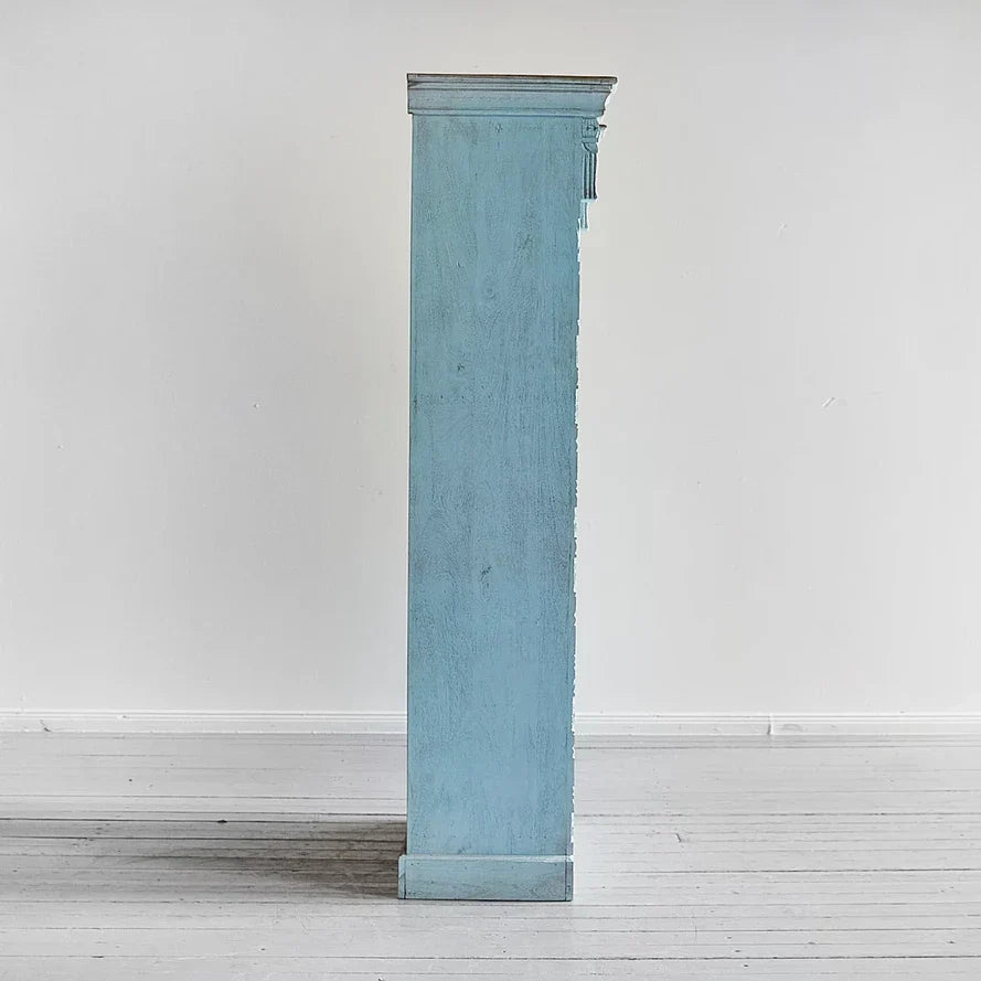 Vintage‑style blue bookcase with jharokha detailing, mango wood construction.

