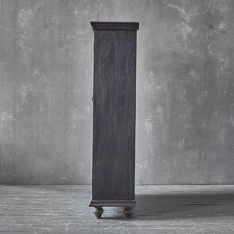 Tall dark wooden cabinet against a gray textured wall