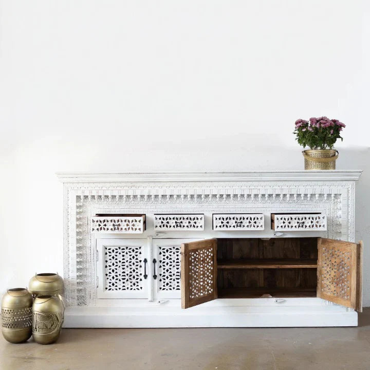 hand carved sideboard, mango wood sideboard, distressed white sideboard, floral carved sideboard, openwork sideboard, 4 door sideboard, 4 drawer sideboard, buffet sideboard, indian carved furniture, storage sideboard, dining room buffet, living room sideboard, entryway sideboard, statement sideboard, large sideboard, handmade sideboard, artisan made sideboard, premium wood buffet, quality wood furniture, durable sideboard, sturdy buffet, timeless sideboard, elegant buffet, grand sideboard, heirloom buffet, 