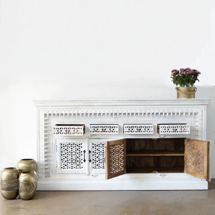 hand carved sideboard, mango wood sideboard, distressed white sideboard, floral carved sideboard, openwork sideboard, 4 door sideboard, 4 drawer sideboard, buffet sideboard, indian carved furniture, storage sideboard, dining room buffet, living room sideboard, entryway sideboard, statement sideboard, large sideboard, handmade sideboard, artisan made sideboard, premium wood buffet, quality wood furniture, durable sideboard, sturdy buffet, timeless sideboard, elegant buffet, grand sideboard, heirloom buffet, 