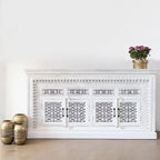 hand carved sideboard, mango wood sideboard, distressed white sideboard, floral carved sideboard, openwork sideboard, 4 door sideboard, 4 drawer sideboard, buffet sideboard, indian carved furniture, storage sideboard, dining room buffet, living room sideboard, entryway sideboard, statement sideboard, large sideboard, handmade sideboard, artisan made sideboard, premium wood buffet, quality wood furniture, durable sideboard, sturdy buffet, timeless sideboard, elegant buffet, grand sideboard, heirloom buffet, 
