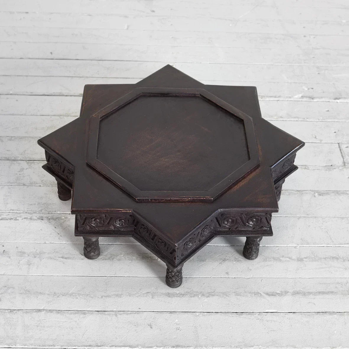 Traditional low table with geometric scroll carving, dark walnut mango wood.

