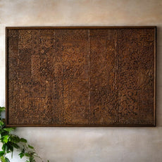Ornamental carved wooden panel featuring intricate floral and geometric designs.
