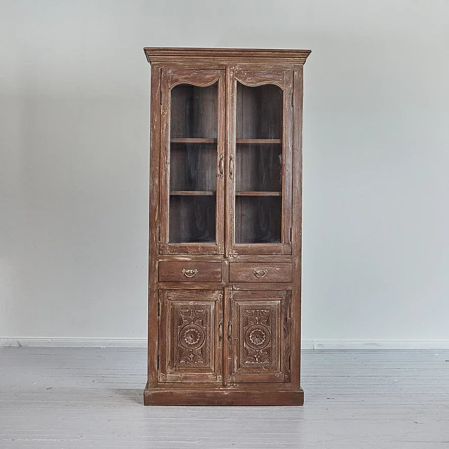 Wooden cabinet with glass doors on a plain background