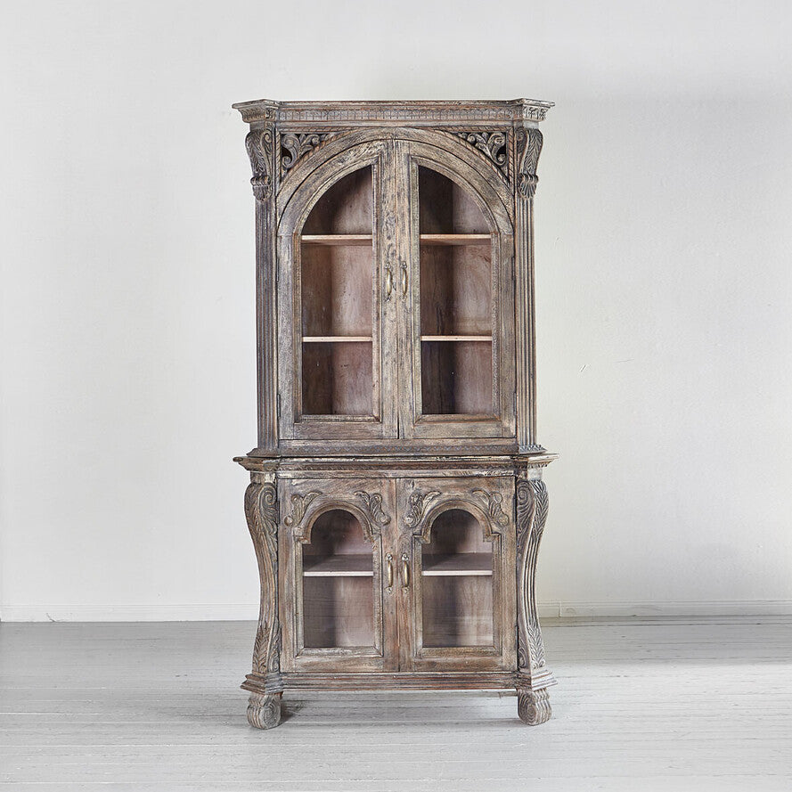 Vintage wooden cabinet with intricate carvings on a white background